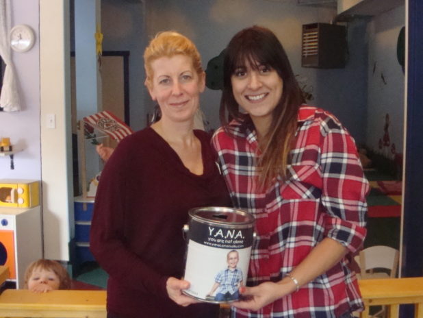 Evangeline Mathura from Playhouse Café with the proceeds from their Valentine's 