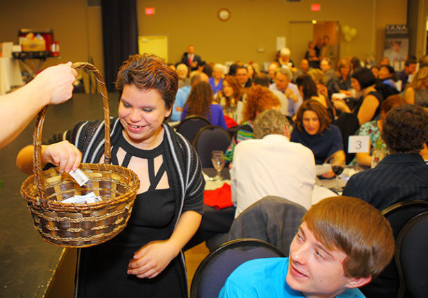 Roberta Williams picks the winning ticket for the West Jet Raffle at 2015 YANA Dinner and Auction. Picture credit to Ron Pogue Photography.