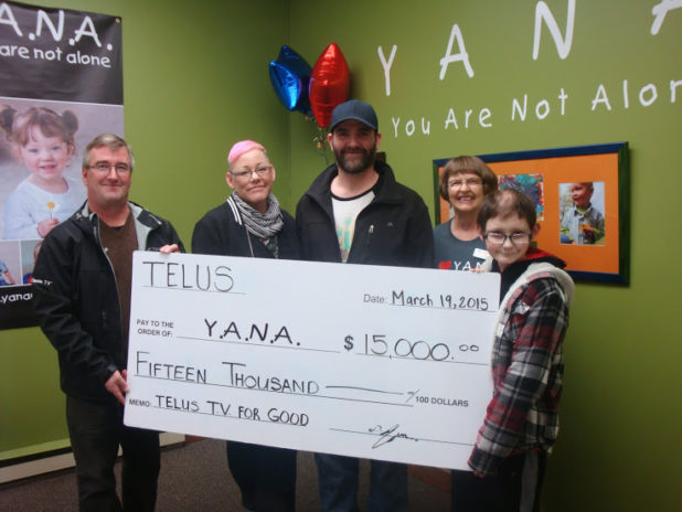 Comox Valley Telus manager Dirk Jezierski presents to Markus Yule on behalf of YANA. Yvonne Yule, Mark Yule, Judy Cryer 